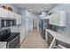 Modern kitchen featuring stainless steel appliances, ample cabinet space, and tile flooring at 4168 Aberdeen Ln, Lake Wales, FL 33859