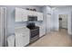 Close-up of a kitchen with stainless steel appliances, and white cabinets and countertops at 4168 Aberdeen Ln, Lake Wales, FL 33859