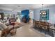 Open-concept living room and dining area with tile flooring, blue accent wall, and comfortable seating at 4168 Aberdeen Ln, Lake Wales, FL 33859