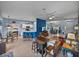 Open floor plan featuring a kitchen bar, living room, and dining area with tile flooring and blue accent walls at 4168 Aberdeen Ln, Lake Wales, FL 33859