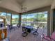 Screened lanai featuring brick floor with beautiful lake view, ceiling fan, and patio furniture at 4168 Aberdeen Ln, Lake Wales, FL 33859