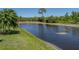 Scenic view of a tranquil lake surrounded by lush green grass and mature trees at 4168 Aberdeen Ln, Lake Wales, FL 33859