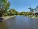 Calm lake view showcasing the serene setting, with mature trees and well-manicured lawns along the banks at 4168 Aberdeen Ln, Lake Wales, FL 33859