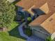 An aerial view of the front of this home with a beautifully landscaped front yard, lawn, and garage at 4485 Turnberry Ln, Lake Wales, FL 33859