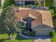 A lovely aerial view of this home with a landscaped front yard and screened-in porch, perfect for outdoor relaxation at 4485 Turnberry Ln, Lake Wales, FL 33859