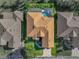 This aerial view showcases a pool and surrounding yard in addition to the detailed roof design at 4485 Turnberry Ln, Lake Wales, FL 33859