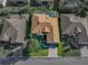 The aerial view highlights a sparkling pool, landscaped backyard, and classic brown roof at 4485 Turnberry Ln, Lake Wales, FL 33859