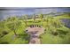 Beautifully landscaped memorial site with walking path, lake view, and American flag at 4485 Turnberry Ln, Lake Wales, FL 33859