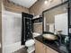 Cozy bathroom featuring a glass bowl sink atop a black granite countertop and a black shower curtain with bamboo accents at 4485 Turnberry Ln, Lake Wales, FL 33859