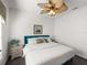 Comfortable bedroom featuring a blue cushioned frame bed, a ceiling fan, and walls painted a bright white at 4485 Turnberry Ln, Lake Wales, FL 33859