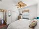 Bright bedroom featuring an Eiffel Tower decoration, a ceiling fan, and a closet with white double doors at 4485 Turnberry Ln, Lake Wales, FL 33859