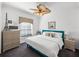 Comfortable bedroom featuring a blue cushioned frame bed, a ceiling fan, and decor reminiscent of Paris, France at 4485 Turnberry Ln, Lake Wales, FL 33859