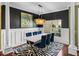 Stylish dining room with chic zebra rug, elegant chandelier, and wainscoting at 4485 Turnberry Ln, Lake Wales, FL 33859