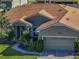 Well-manicured lawn and mature landscaping leading to this single Gathering home with attached garage at 4485 Turnberry Ln, Lake Wales, FL 33859