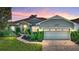 Charming single-story home with lush landscaping, brick driveway and a warm, inviting ambiance at 4485 Turnberry Ln, Lake Wales, FL 33859