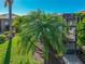Exterior view of the home showcases a screened-in patio and lush palm trees, enhancing the backyard's tropical ambiance at 4485 Turnberry Ln, Lake Wales, FL 33859