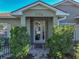 Attractive front entrance with glass doors, brick walkway, and well-maintained landscaping at 4485 Turnberry Ln, Lake Wales, FL 33859