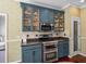 This lovely kitchen features stainless steel appliances, blue cabinets and a walk-in pantry at 4485 Turnberry Ln, Lake Wales, FL 33859