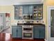 Cozy kitchen featuring stainless steel appliances and blue cabinetry at 4485 Turnberry Ln, Lake Wales, FL 33859