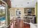 Eat-in kitchen and breakfast bar with hardwood floors and pool view at 4485 Turnberry Ln, Lake Wales, FL 33859