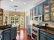 The kitchen features stainless steel appliances, blue cabinets and an adjacent dining area at 4485 Turnberry Ln, Lake Wales, FL 33859