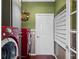 Well-maintained laundry room featuring red washer and dryer appliances and an olive green wall color at 4485 Turnberry Ln, Lake Wales, FL 33859