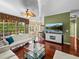 Bright living area with hardwood floors, comfortable seating, and view of the pool through large windows at 4485 Turnberry Ln, Lake Wales, FL 33859