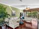 Spacious living room with plush couches, large windows, hardwood floors, and indoor palm at 4485 Turnberry Ln, Lake Wales, FL 33859
