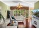 Elegant living room with hardwood floors, white couches, and bright, natural lighting at 4485 Turnberry Ln, Lake Wales, FL 33859