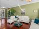 Comfortable living room with a plush sectional sofa and indoor palm at 4485 Turnberry Ln, Lake Wales, FL 33859