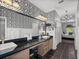 Large main bathroom with granite counters, black and white wallpaper, and dual sinks at 4485 Turnberry Ln, Lake Wales, FL 33859