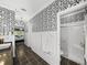 Spacious main bathroom with black-and-white wallpaper, shower, and granite counters at 4485 Turnberry Ln, Lake Wales, FL 33859