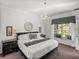 Bright main bedroom features a chandelier, a large window, and matching furniture at 4485 Turnberry Ln, Lake Wales, FL 33859