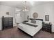 Elegant main bedroom features a chandelier, accent mirror and black and white color scheme at 4485 Turnberry Ln, Lake Wales, FL 33859
