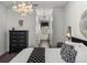 Bright main bedroom with chandelier, and open access to the main bathroom at 4485 Turnberry Ln, Lake Wales, FL 33859