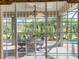 View of a well-designed patio and garden area, seen through a wall of glass at 4485 Turnberry Ln, Lake Wales, FL 33859
