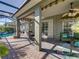 Inviting covered patio with ceiling fan, dining set, comfortable seating, and access to the pool area for relaxation and entertainment at 4485 Turnberry Ln, Lake Wales, FL 33859