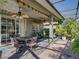 Charming patio with a dining area, comfortable seating, and views of the screened outdoor area at 4485 Turnberry Ln, Lake Wales, FL 33859