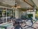 Relaxing covered patio featuring comfortable seating and ceiling fans, ideal for enjoying the outdoors at 4485 Turnberry Ln, Lake Wales, FL 33859