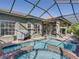 Screened pool and spa with covered patio. Perfect for outdoor entertaining and enjoying the Florida lifestyle at 4485 Turnberry Ln, Lake Wales, FL 33859
