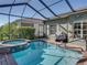 Enjoy the pool with a spa, surrounded by lush landscaping and a screened enclosure for year-round enjoyment at 4485 Turnberry Ln, Lake Wales, FL 33859