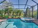 Relaxing screened-in pool and spa provide a private outdoor escape with views of the well-maintained backyard at 4485 Turnberry Ln, Lake Wales, FL 33859