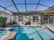 Sparkling pool and spa in a screened enclosure, offering a private outdoor oasis with ample space for entertaining at 4485 Turnberry Ln, Lake Wales, FL 33859