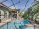 Enclosed pool and spa offer a relaxing retreat in this screened-in outdoor space, with lush landscaping for privacy at 4485 Turnberry Ln, Lake Wales, FL 33859