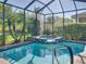 Beautiful pool and spa area with lush landscaping, creating a private backyard retreat for relaxation and recreation at 4485 Turnberry Ln, Lake Wales, FL 33859