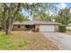 Charming brick home with a well-maintained lawn and mature trees providing ample shade at 4615 Reynosa Sw Dr, Winter Haven, FL 33880