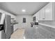 The updated kitchen has white cabinets, granite counters, stainless steel appliances and recessed lighting at 4615 Reynosa Sw Dr, Winter Haven, FL 33880
