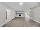 Open floor plan featuring the living room with a modern fireplace, fresh paint, and wood-look floors at 4615 Reynosa Sw Dr, Winter Haven, FL 33880