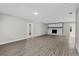Living room features wood-look floors, fresh paint, modern fireplace with white stone, and open layout at 4615 Reynosa Sw Dr, Winter Haven, FL 33880