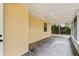 Covered screened in porch features stucco wall, concrete floor, window, and white ceiling at 4615 Reynosa Sw Dr, Winter Haven, FL 33880